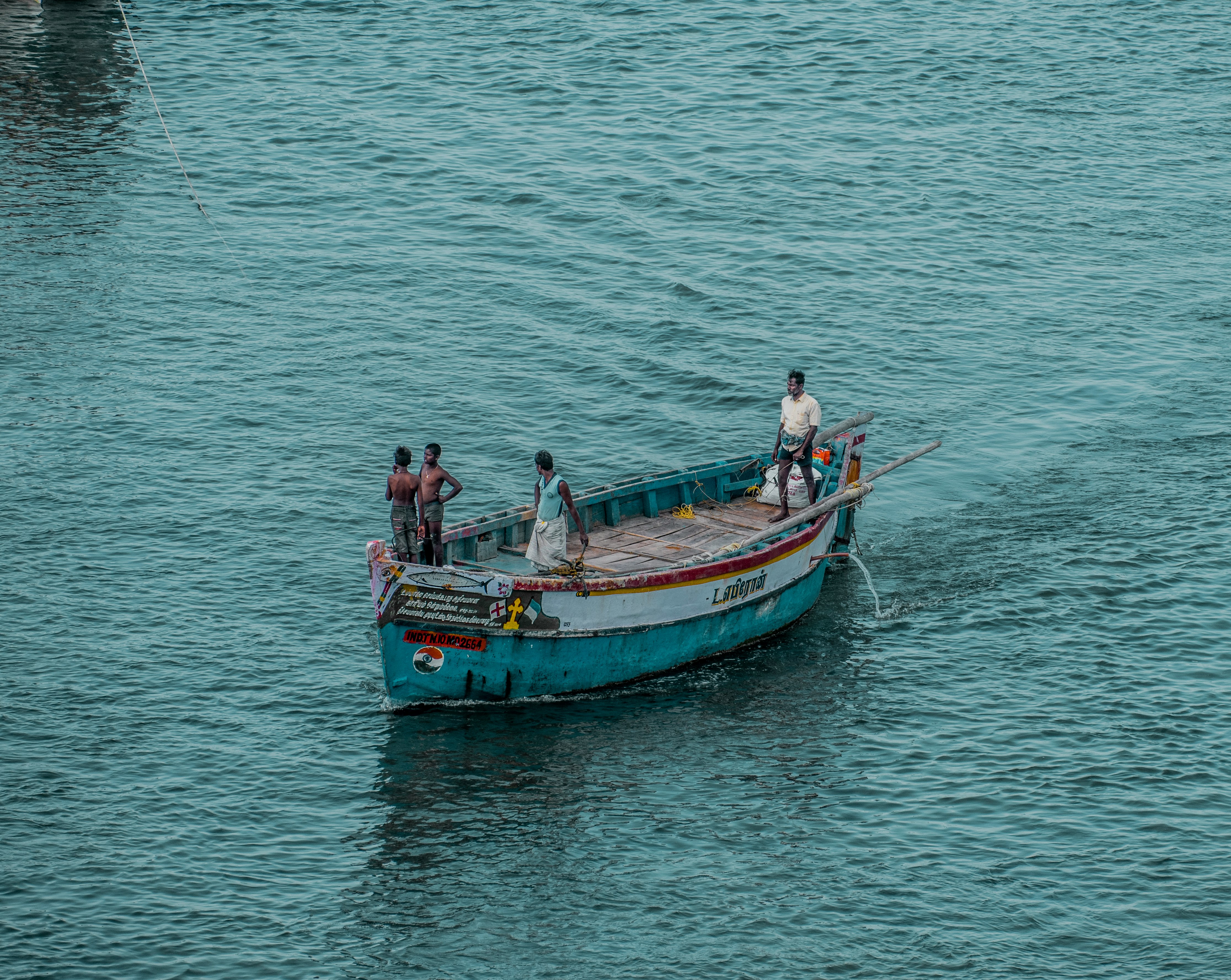 2 men and woman riding on boat on sea during daytime